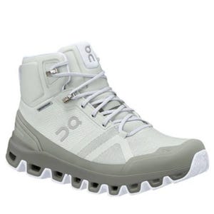 A light gray, high-top athletic shoe with rugged, cushioned sole and lace-up design, featuring the \“On\“ brand logo.