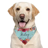 A Labrador Retriever wearing a floral-patterned bandana with the name \“Bailey\“ written on it.