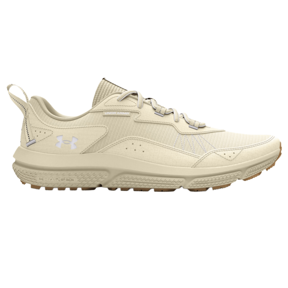 Under Armour athletic shoe in a beige color with a textured sole, featuring a logo on the side and on the back heel tab.