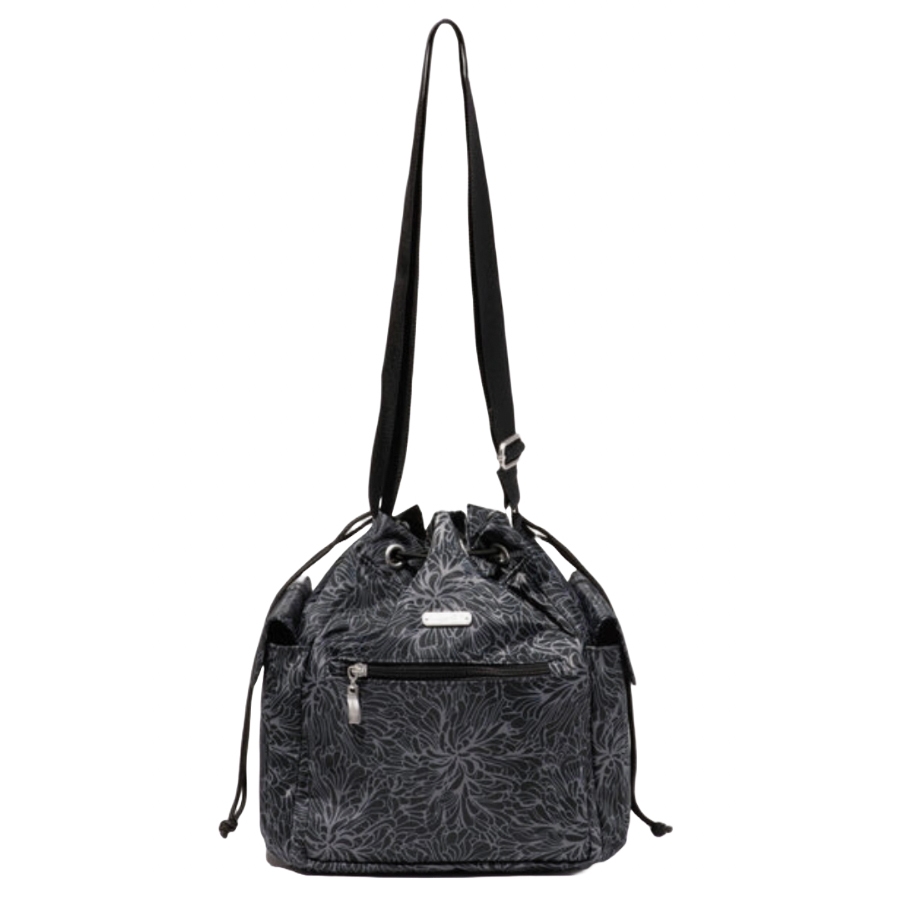 Baggallini Drawstring Crossbody is a black handbag with a floral pattern, featuring a drawstring closure, adjustable strap, and front zippered pocket.