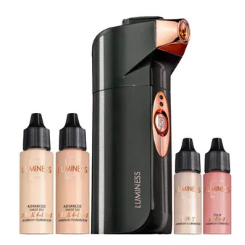 An airbrush makeup kit by Luminess, featuring a portable airbrush device and four foundation bottles in varying shades.