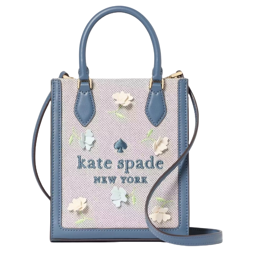 Kate Spade Ellie Applique Mini Tote features blue leather accents with floral appliques on a mesh background, dual handles, and a removable shoulder strap. The bag includes a \“kate spade NEW YORK\“ logo on the front.