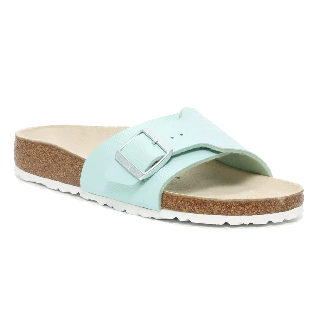 A light blue sandal with a single strap featuring an adjustable buckle, cork sole, and textured rubber outsole.