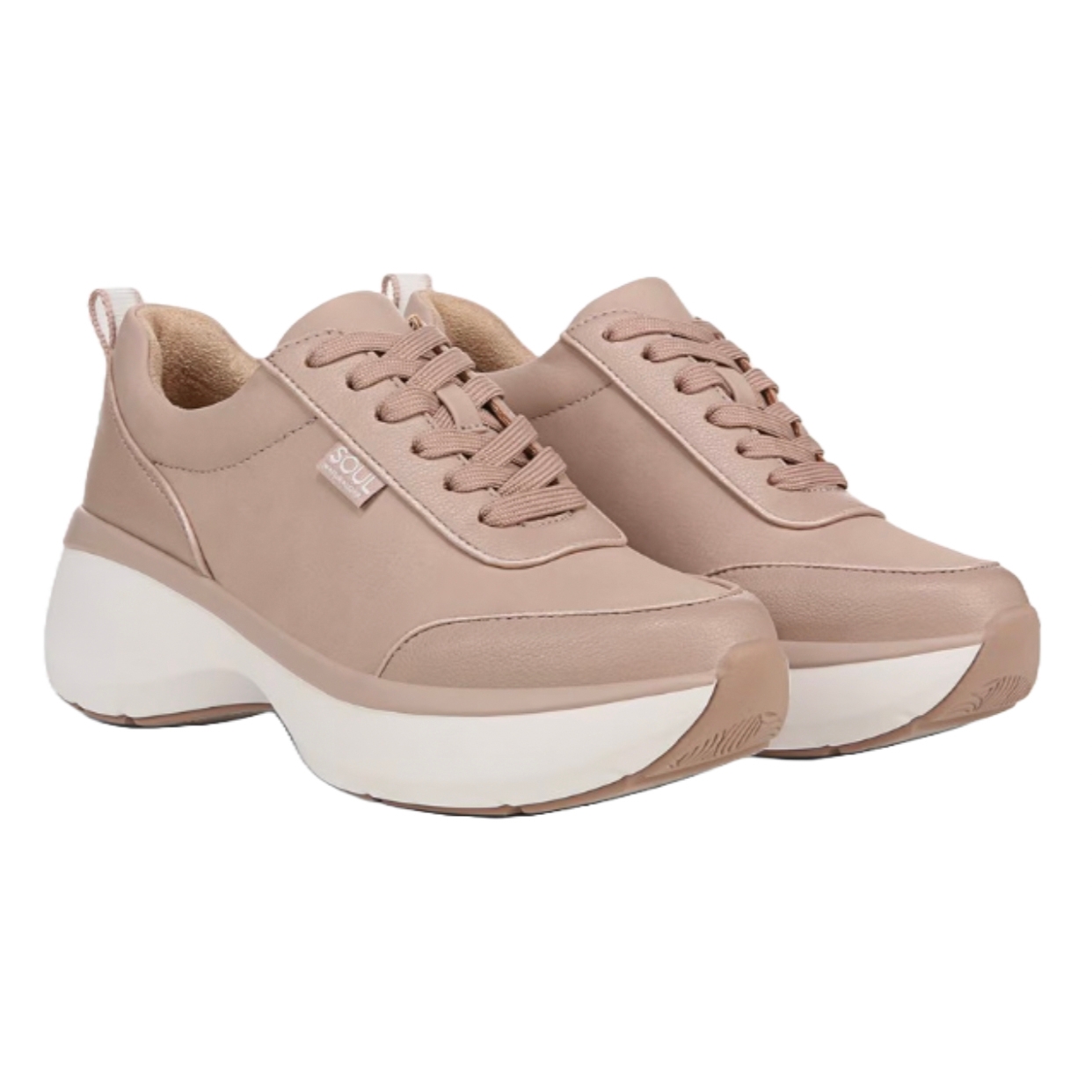 Beige sneakers with a chunky white sole, featuring lace-up design and a small label tag on the side.