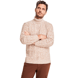 A man is wearing a beige cable-knit turtleneck sweater paired with brown cargo pants.