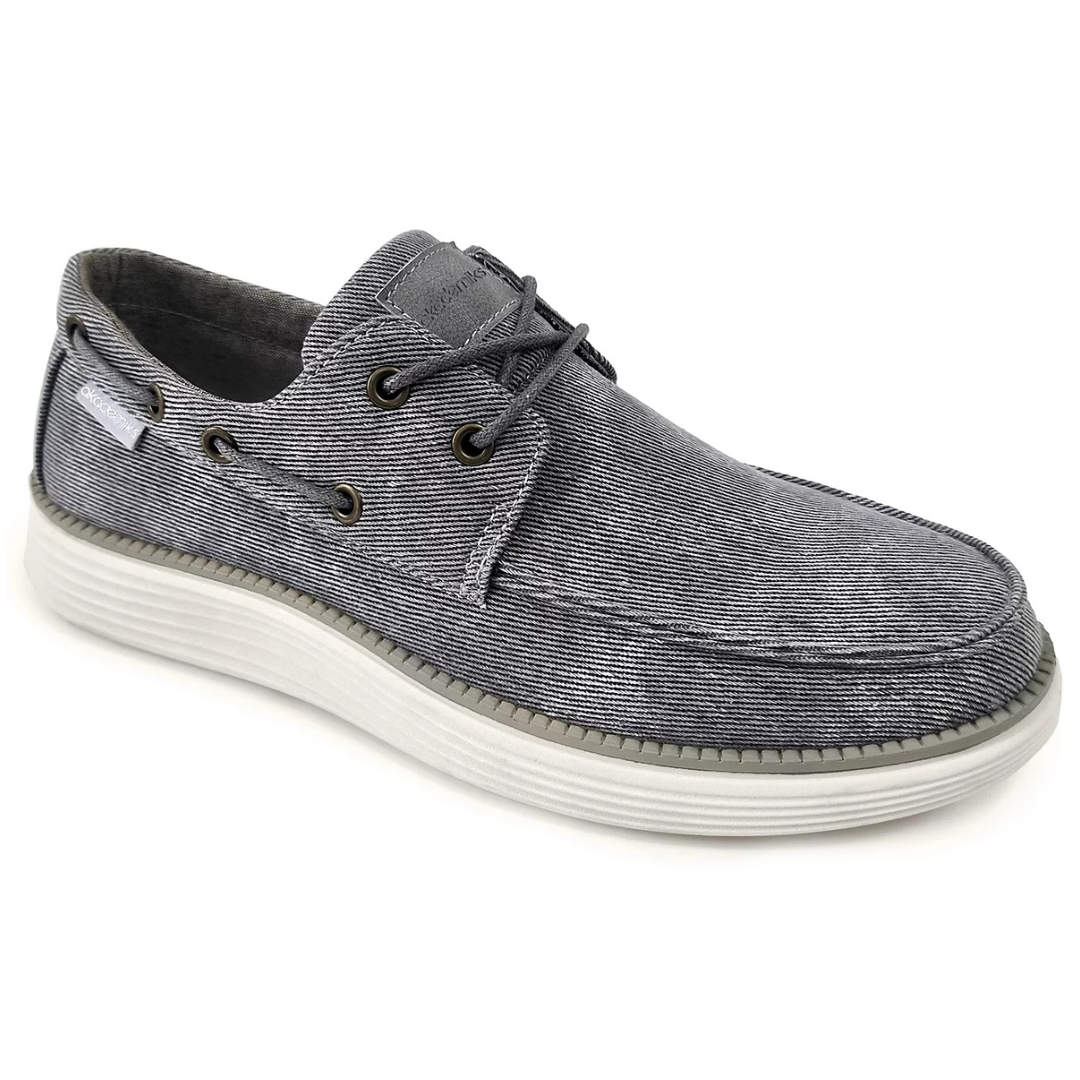 A casual denim-style boat shoe with a white rubber sole, lace-up closure, and metal eyelets, ideal for everyday wear.
