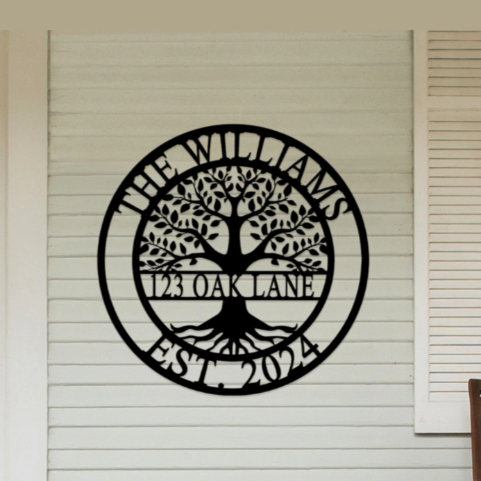 A decorative wall sign is displayed with a tree design and the text \“The Williams, 123 Oak Lane, Est. 2024\“ on a home's exterior wall.