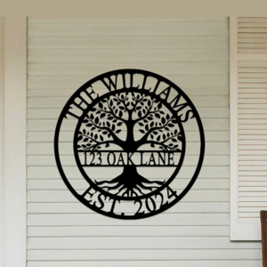 A decorative wall sign is displayed with a tree design and the text \“The Williams, 123 Oak Lane, Est. 2024\“ on a home's exterior wall.