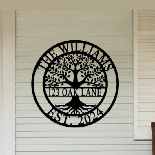A decorative wall sign is displayed with a tree design and the text \“The Williams, 123 Oak Lane, Est. 2024\“ on a home's exterior wall.