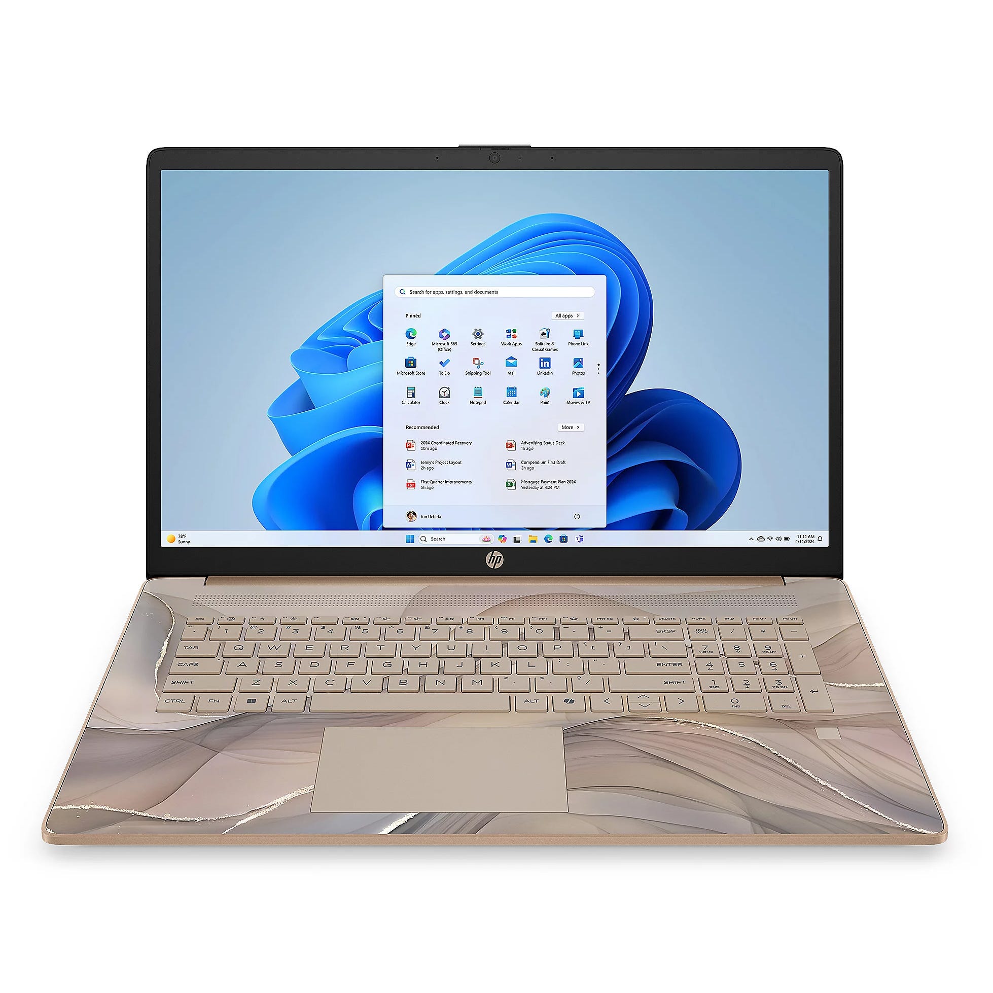 HP laptop with a patterned design, featuring a keyboard and Windows 11 interface on the screen.
