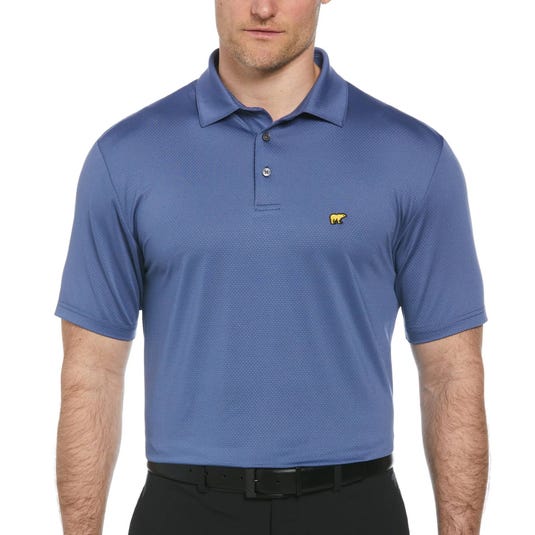 A blue polo shirt with a yellow bear logo on the chest, worn by a man in black pants.