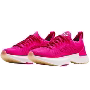 Bright pink lululemon Chargefeel 3 shoes with a breathable knit upper, white midsoles, and gum rubber outsoles. The design features laces and a logo on the tongue.