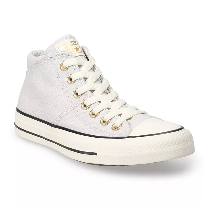 A white high-top canvas sneaker with laces and gold eyelets.
