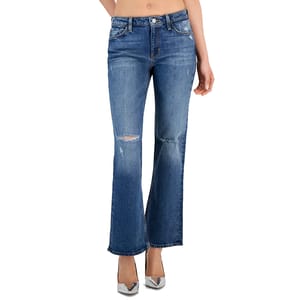 A pair of distressed blue flare jeans and silver high-heeled shoes.