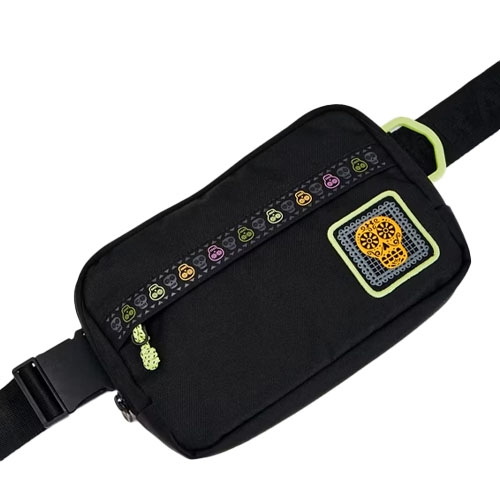 Black belt bag featuring colorful skull designs on the zipper and a large skull patch on the front, accented with green elements.