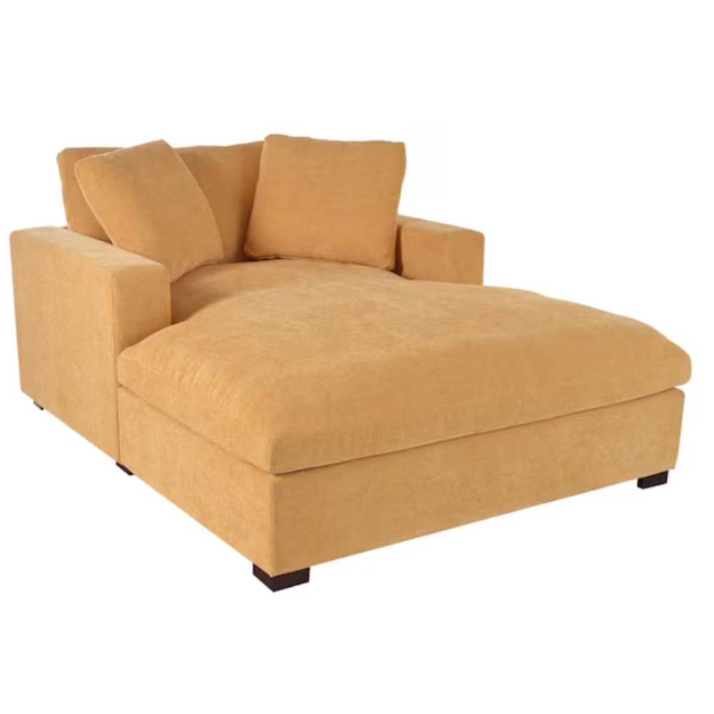 A large, mustard-yellow chaise lounge with plush cushions and dark wooden legs.