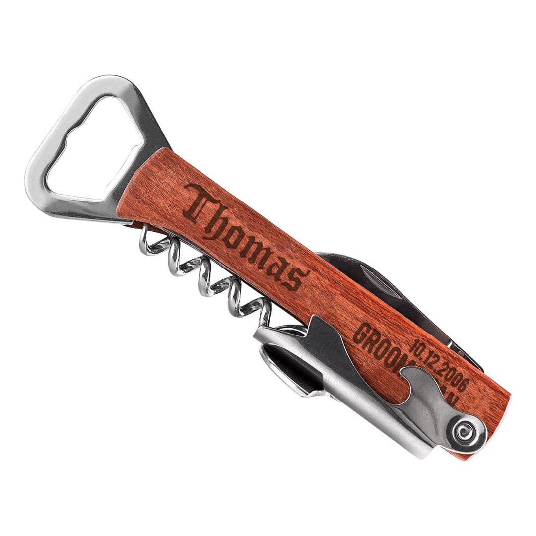 A wooden-handled multi-tool corkscrew engraved with the name \“Thomas\“ and the date \“10.12.2006,\“ featuring a bottle opener and foil cutter.