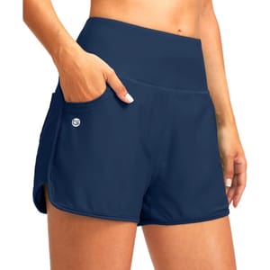 Navy blue women's swim shorts with a high-waisted design, featuring side pockets and a small logo on the left.