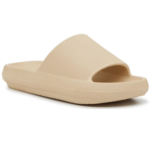 Beige slide sandal with a textured strap and cushioned sole.