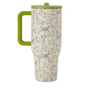A travel mug with a green lid and handle features a whimsical pattern of various dogs and martini glasses.