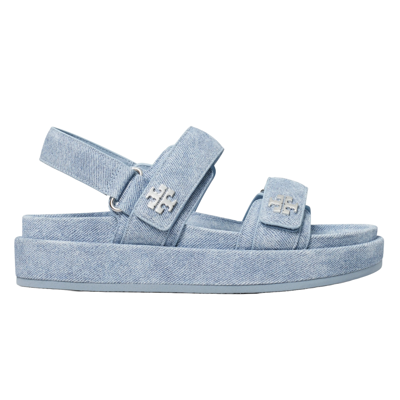 Tory Burch Kira Platform Sandals are light blue denim with a chunky sole and adjustable straps. They feature the Tory Burch logo in metallic detail on the straps.