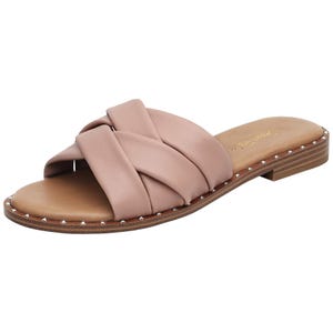 A pair of pale pink flat sandals with crisscrossed leather straps.