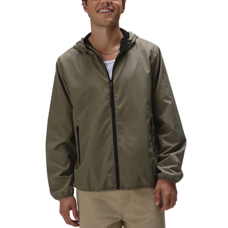 A person wearing an olive green zip-up hooded jacket with black trim and beige pants.