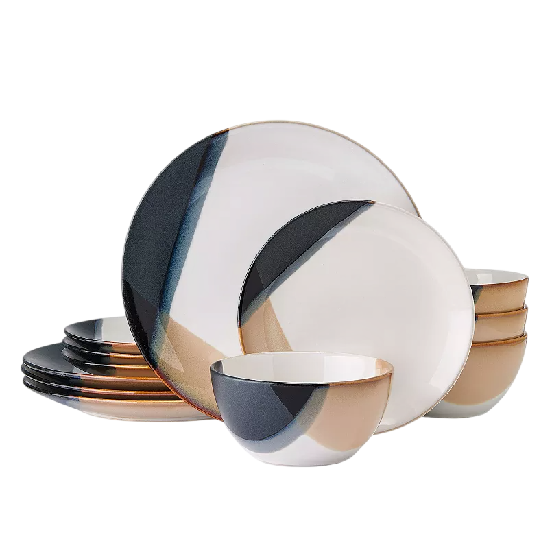 A set of dinnerware featuring plates and bowls with an abstract design in black, tan, and white colors.