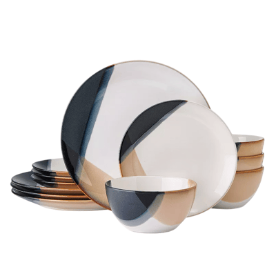 A set of dinnerware featuring plates and bowls with an abstract design in black, tan, and white colors.