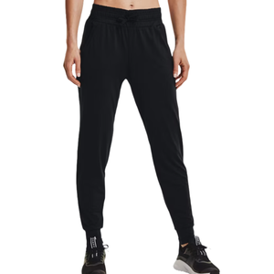 Men's black jogger-style pants by Under Armour with an elastic waistband and drawstring, featuring side pockets and cuffed hems. Worn with black athletic shoes.