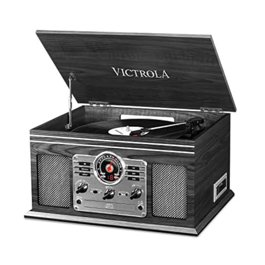 A vintage-style record player with a wooden finish, featuring a radio dial and built-in speakers, under the brand name Victrola.