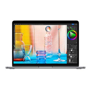 A laptop displaying a graphic design software interface with vibrant glass artwork.