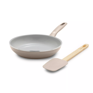A beige non-stick frying pan with an ergonomic handle and a matching spatula featuring a wooden grip.