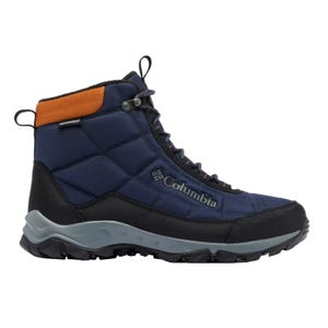 Columbia waterproof hiking boot in navy blue with black and orange accents, featuring a rugged sole for enhanced traction.