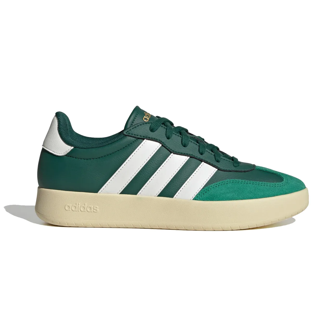 Green and white Adidas sneaker with a beige sole and the brand's signature three stripes.