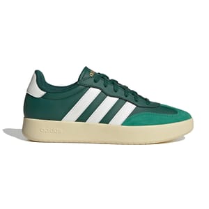 Green and white Adidas sneaker with a beige sole and the brand's signature three stripes.