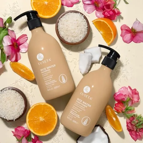 Luseta Rice Water Shampoo and Conditioner are shown with rice, coconut, orange slices, and pink flowers for a natural aesthetic.