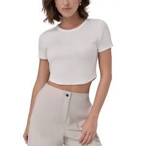 White ribbed crop top with short sleeves and a round neckline, featuring a fitted and slightly textured design.