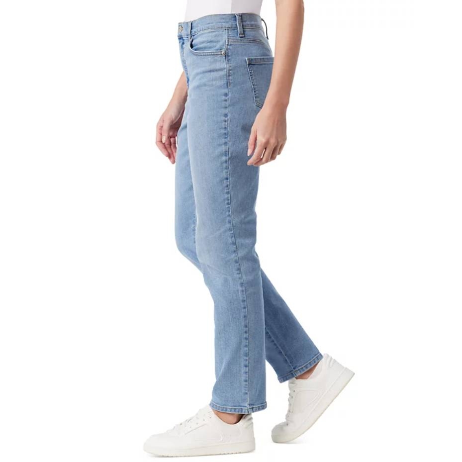 A person wearing light blue straight-leg jeans paired with white sneakers.