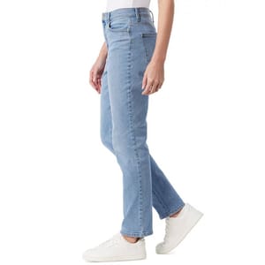 A person wearing light blue straight-leg jeans paired with white sneakers.