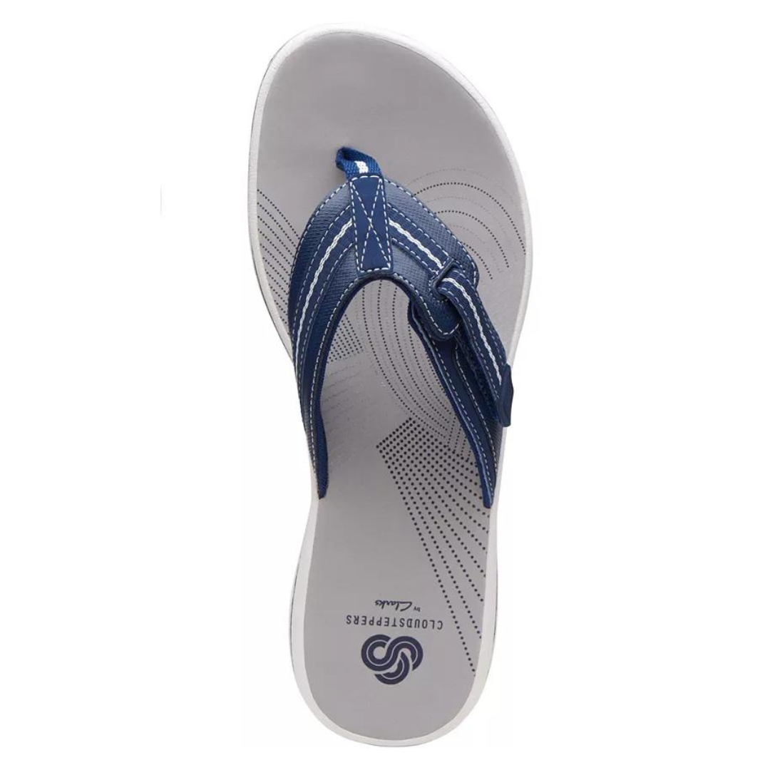 A single navy blue flip-flop with a white sole and dotted pattern.