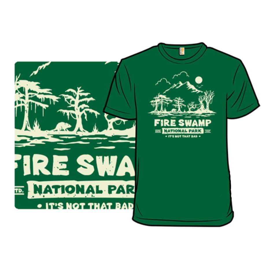 Green T-shirt with a design featuring \“Fire Swamp\“ as a national park, including trees and a humorous tagline \“It's Not That Bad.\“