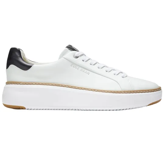 White low-top sneaker with black heel detail, featuring a platform sole and branded with \“Cole Haan\“.