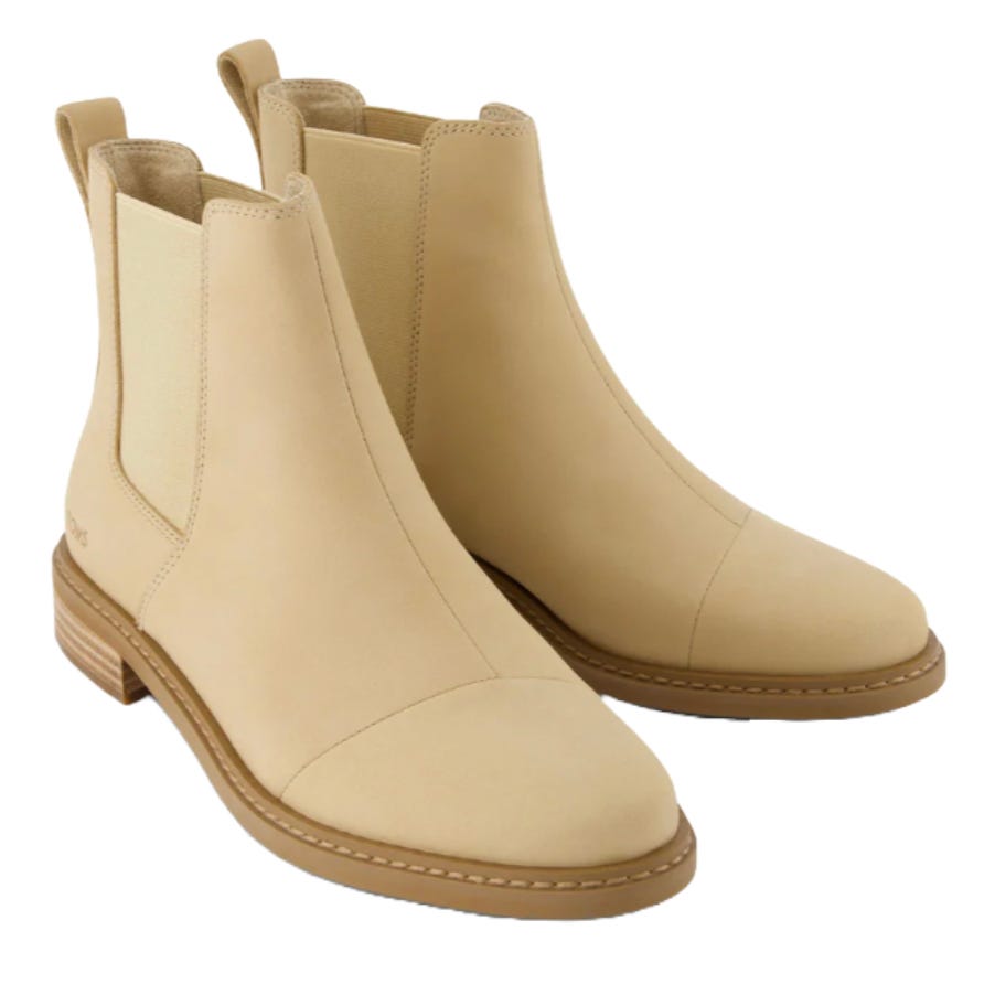 Beige Chelsea boots with a smooth finish, featuring elastic side panels and a low stacked heel.
