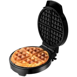 A round waffle maker with an open lid, showing a cooked waffle inside, divided into four sections.