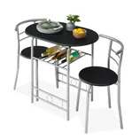 Compact dining set with a black oval table and two chairs featuring silver metal frames. Includes underneath rack storing wine bottles and tabletop decor with a plant and fruit basket. Perfect for small spaces.