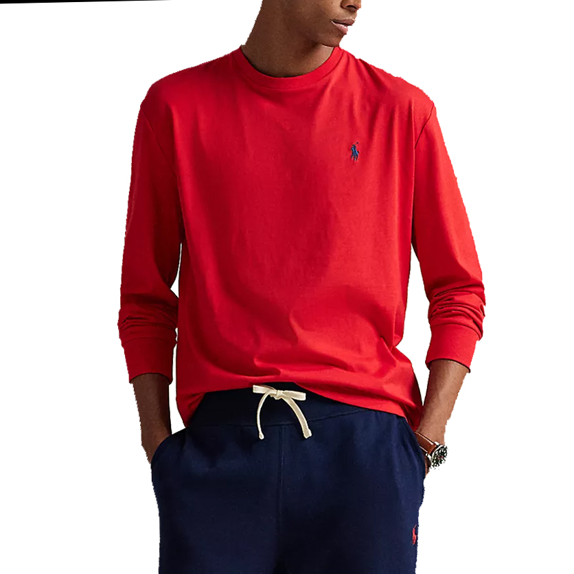A person is wearing a red long-sleeve shirt with a small blue logo on the chest and navy blue pants with a drawstring.