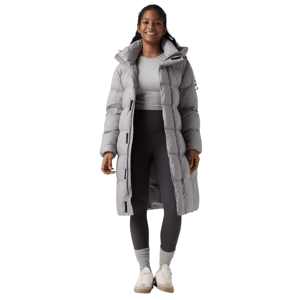 A person wears a long, light gray puffer coat over a light gray shirt with dark gray leggings, gray socks, and white sneakers.