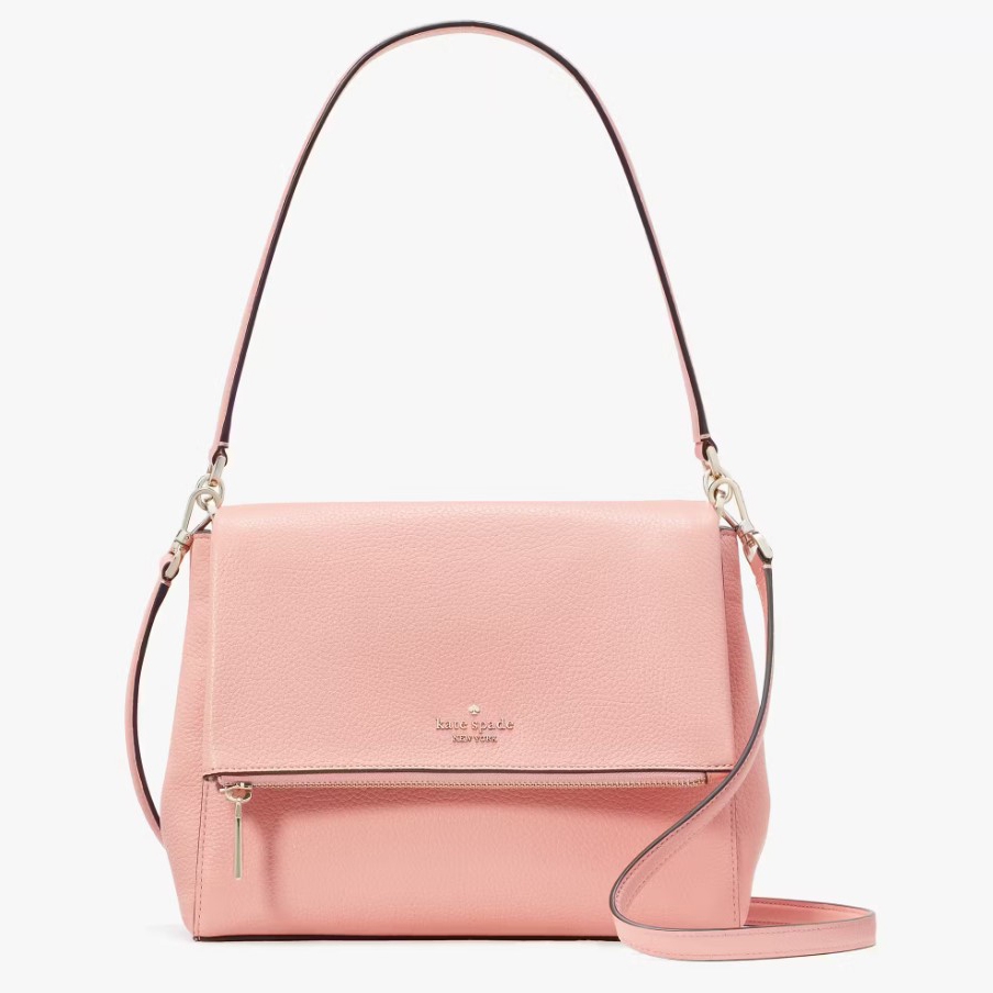 A pale pink Kate Spade shoulder bag with a long strap and a front zipper.