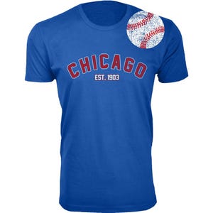 Blue T-shirt with \“CHICAGO EST. 1903\“ in red and white lettering, featuring a distressed baseball graphic on the shoulder.